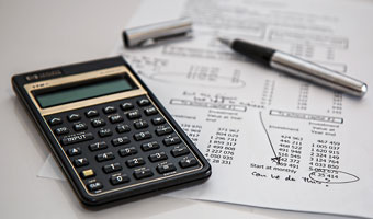Black calculator and ballpoint pen image